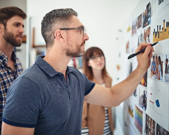 Storyteller with team using whiteboard